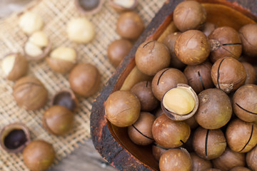 Macadamia nuts on a wooden table. Ripe macadamia nuts closeup