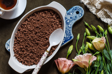 Chocolate crumble with pears and plums and a bunch of flowers