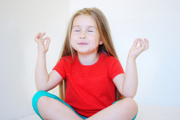 Little cute girl practicing yoga pose