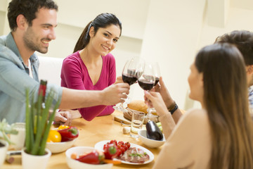 Young people sitting by the table