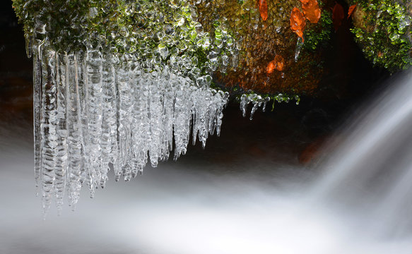 Winter creek with icicles in the national park Sumava,Czech Republic.