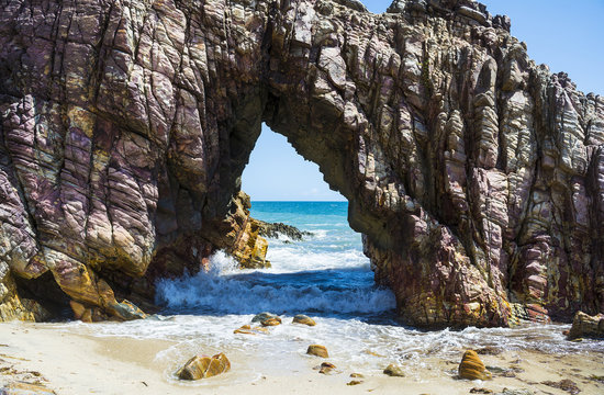 Pedra Furada, stone natural gates on the beach, Jericoacoara, Brazil.