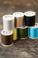 Multi-colored thread on a wooden table