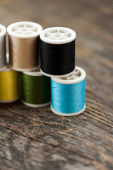 Multi-colored thread on a wooden table