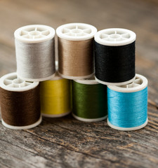 Multi-colored thread on a wooden table