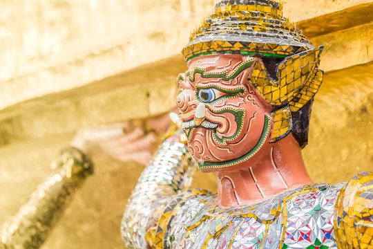 Closeup beautiful Golden Giant in Wat Phra Kaew or the Temple of the Emerald Buddha or Wat Phra Sri Rattana Satsadaram, Bangkok Thailand.