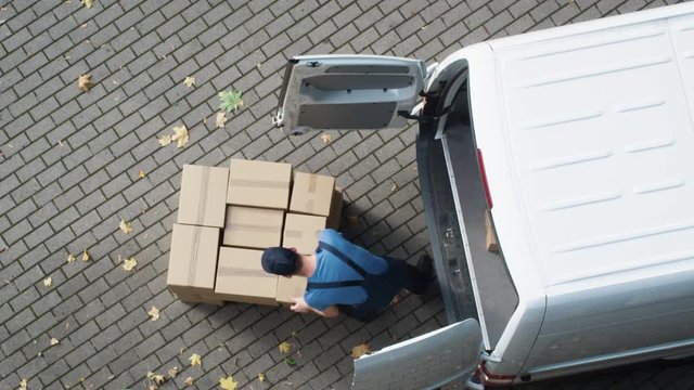 Delivery Man Loads his Commercial Van with Cardboard Boxes. Speed up Video. Shot on RED Cinema Camera in 4K (UHD).