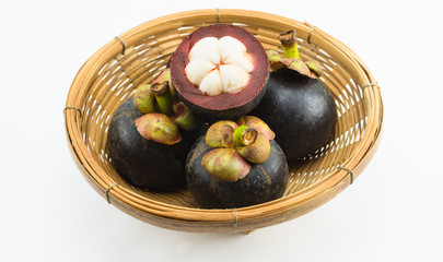 mangosteens in bamboo basket isolated on white background