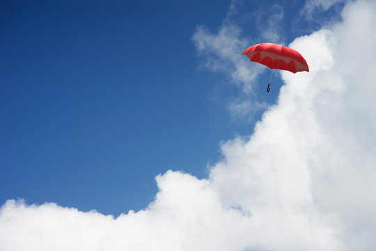 3D Rendering : illustration of Red umbrella floating above against blue sky and clouds. Business, leader concept, being different concepts;1st position