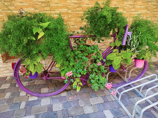 Vintage bicycle equipped with baskets of flowers and leaves