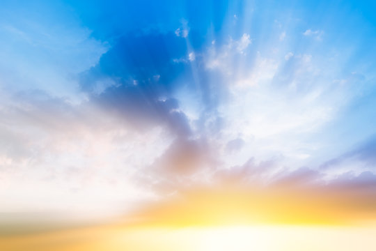 Fototapeta beautiful cloudy blue sky, morning sun rise with sunny bright shining golden light ray from dark cloud, new years background or heaven gate opening concept.