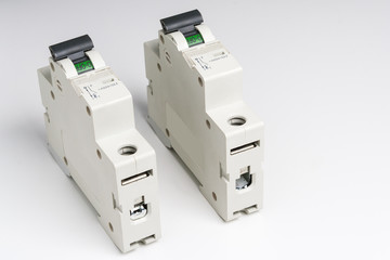 Circuit breakers lie on a white table.