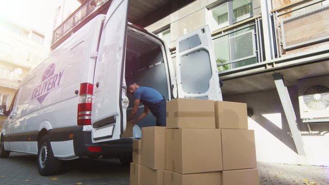 Young Mover Loads his Commercial Vehicle with Large Cardboard Boxes.  Shot on RED Cinema Camera in 4K (UHD).