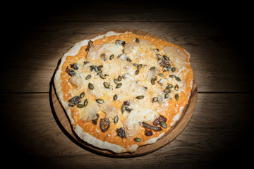 Fruit pizza with pineapple in the dark
