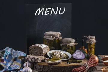 Herrings Pickles. Salted Cucumbers still-life with dark bread