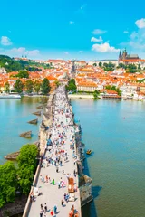 Rolgordijnen Panorama of the old part of Prague from the Old Town Bridge Tower. Beautiful view on the bridge over the river Vltava, district Hradcany and Prague Castle. Old Town architecture, Czech Republic. © LALSSTOCK