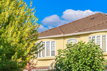 The top of the house or apartment building with nice window.