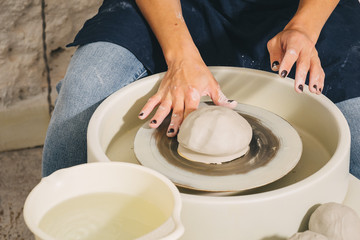 Hands working on pottery wheel