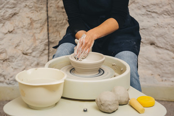 Hands working on pottery wheel