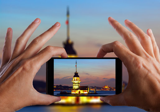 Travel concept. Hand making photo of city with smartphone camera. Istanbul. Turkey
