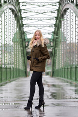 Obraz premium Attractive blonde woman wearing winter jacket on street