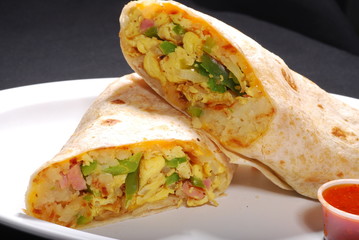Breakfast Burrito with egg and potatoes inside and red  sauce
