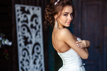 Gorgeous bride young woman in a wedding dress with perfect makeup and hairstyle