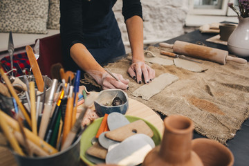 Pottering process.Dirty hands creating dishes