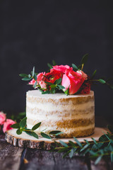 Appetizing wedding cake with flowers in rustic style on dark background - 127232915