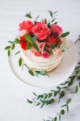 Obraz na płótnie Canvas Appetizing wedding cake with flowers in rustic style on white background