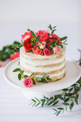 Appetizing wedding cake with flowers in rustic style on white background - 127232967