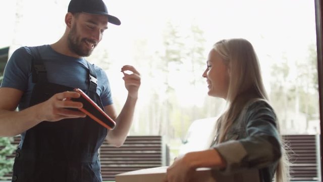 Beautiful Homeowner Opens the Door to Smiling Delivery Man and Receives Parcel After Signing on Electronic Signature Device. Shot on RED Cinema Camera in 4K (UHD).