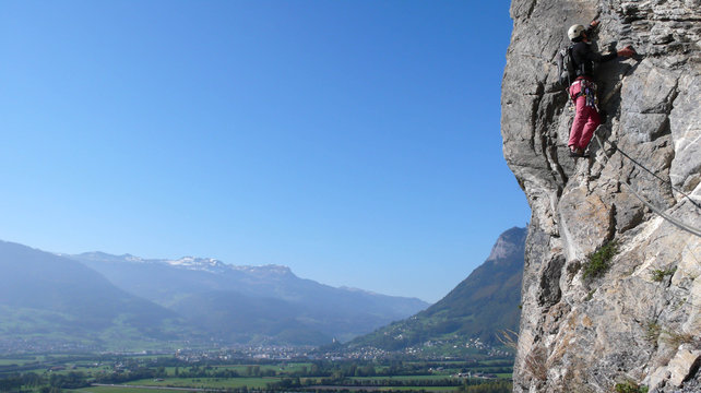 a rock climber on a steep route in the Swiss Alps near Sargans