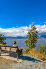 Naklejka na ściany i meble A bench with gorgeous view at mountain lake, British Columbia, Canada.