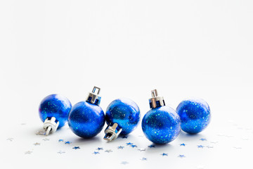 Christmas and New Year background with blue starry decorative balls for Christmas tree. Place for text.