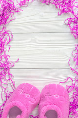 pink baby's bootees on wooden background