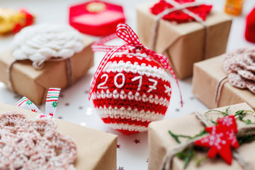 Fototapeta na wymiar Christmas and New Year 2017 background with presents, decorations and crocheted handmade decorative ball.