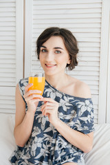 Girl drinking orange juice at Breakfast in bed