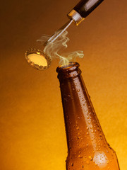 man open fresh cold beer ale bottles with drops and stopper open with bottle opener