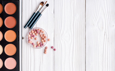 decorative cosmetics on wooden background top view