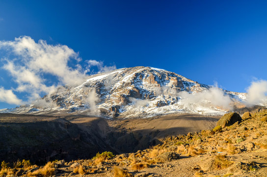 Stunning evening view of Kibo with Uhuru Peak (5895m amsl, highest mountain in Africa) at Mount Kilimanjaro,Kilimanjaro National Park,seen from Karanga Camp at 3995m amsl. Snow and glaciers on summit.