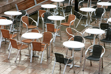 Fototapeta na wymiar Tables and chairs in the open air cafe
