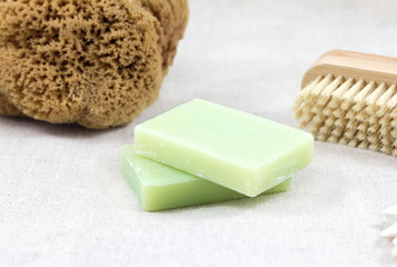 Body care concept. Soap, sea sponge, brush for legs on white background. Spa treatment.