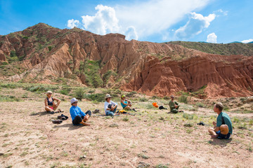 Fototapeta premium A group of yogis in an exotic Fairy Tale canyon, Kyrgyzstan.