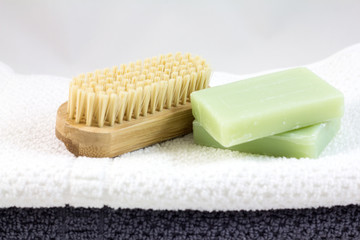 Soap and brush for legs on towel