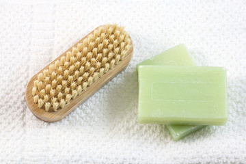 Soap and brush for legs on towel