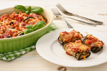 Roasted eggplants stuffed with minced meat and baked with tomatoes and cheese.