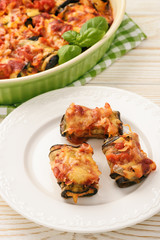 Roasted eggplants stuffed with minced meat and baked with tomatoes and cheese.
