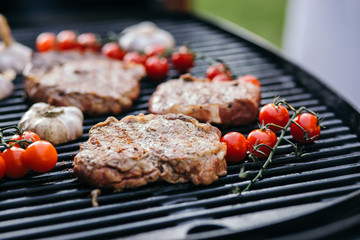 Grilled steak with vegetables in a pan. Close-up.