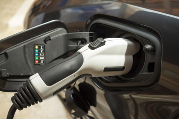 Obraz na płótnie Canvas Electric car recharging at electric charging station